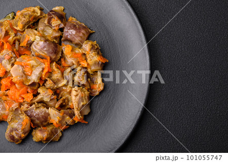 Delicious stewed chicken gizzards with carrots and tomato 101055747