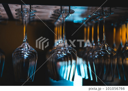 set of shiny dry wineglasses over bar counter in nightclub 101056766