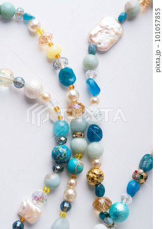 author trend necklace with different beads demonstrated against white background. fashion and jewelry concept author trend necklace with different beads demonstrated against white background. fashion and jewelry concept 101057855