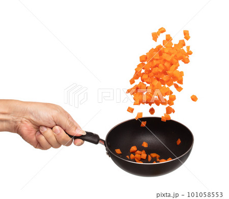 Carrot fresh fly float in Air turn to Cube dice shape. Beta Carotene orange color in Carrot is good health. Many Dice cube carrot flying throw up in Air by cooking pan. White background isolated 101058553