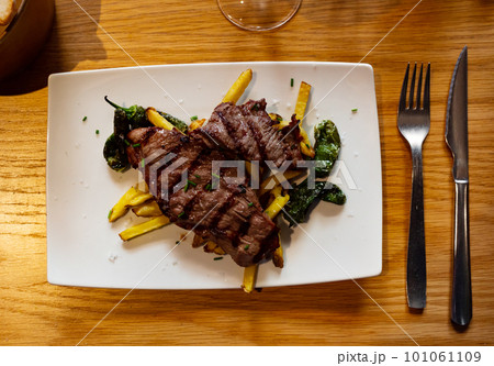 Fried beef served with potatoes and peppers Fried beef served with potatoes and peppers 101061109