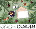 December 13. Calendar date, white blank with craft envelope, cup of tea and natural decor on green background. Hello winter. Template for your design, greeting card 101061486