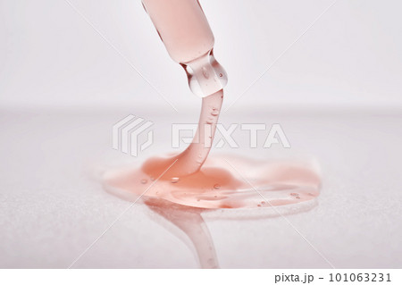 Pipette with a viscous pink cosmetic close-up. 101063231