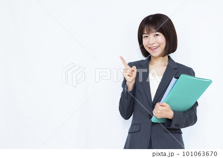 白い背景の前で指を指すスーツ姿の30代ビジネスウーマン 101063670