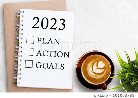 2023 PLAN ACTION GOALS Text on Blank notebook on white office desk background. 101063739