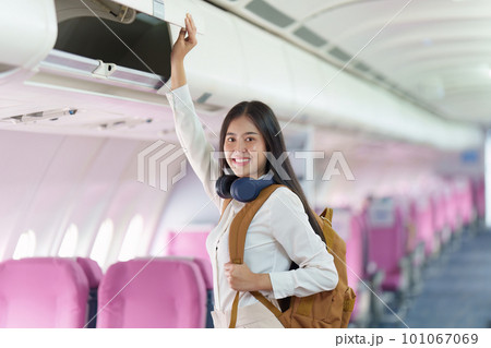 Beautiful Asian traveler woman with backpack when flight is landing. Travel, Airplane concept 101067069