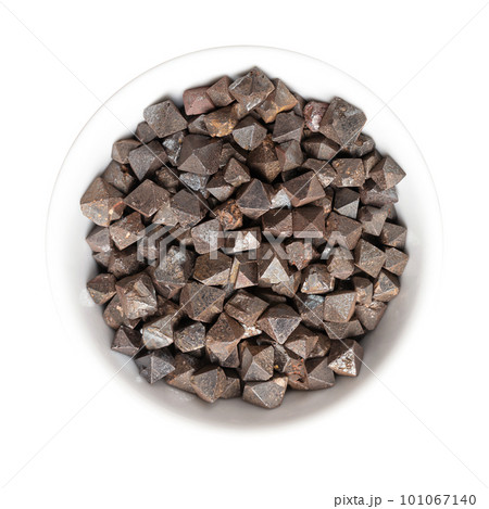 Magnetite crystals in a white bowl. Iron(II,III) oxide, octahedral, double pyramid and Platonic solid shaped. Most magnetic of all naturally occurring minerals. Can also be found in the human brain. 101067140