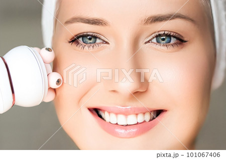 Anti-aging cosmetology and beauty treatment product, woman using face contour massage roller device as facelift procedure and skincare routine, close-up Anti-aging cosmetology and beauty treatment product, woman using face contour massage roller device as facelift procedure and skincare routine, close-up 101067406
