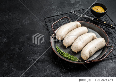 Traditional German Bavarian white sausage in steel tray with mustard. Black background. Top view. Copy space 101069374