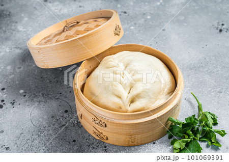 Pyanse steamed bun in a Bamboo steamer, korean street food. Gray background. Top view Pyanse steamed bun in a Bamboo steamer, korean street food. Gray background. Top view 101069391