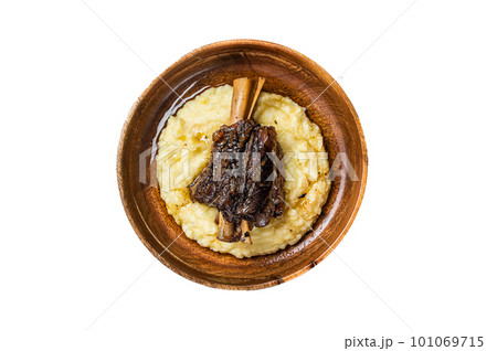 Braised lamb shank on the mashed potato in a plate. Isolated on white background Braised lamb shank on the mashed potato in a plate. Isolated on white background 101069715
