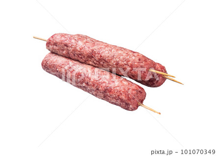 Raw kofta or lula kebabs skewers on butcher board. Isolated on white background Raw kofta or lula kebabs skewers on butcher board. Isolated on white background 101070349