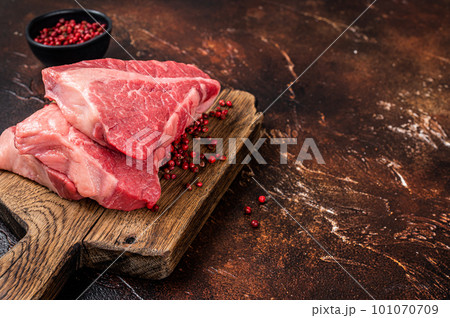 Raw sirloin beef cut, Silverside steak on a wooden board. Dark background. Top view. Copy space Raw sirloin beef cut, Silverside steak on a wooden board. Dark background. Top view. Copy space 101070709