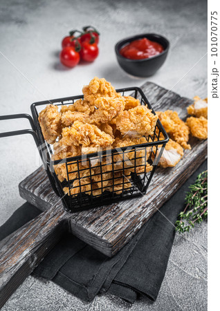 Dip Fried chicken popcorn with ketchup in a basket. White background. Top view Dip Fried chicken popcorn with ketchup in a basket. White background. Top view 101070775