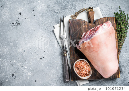 Uncooked Raw pork ham hocks, shanks on a wooden board with spices. Gray background. Top view. Copy space Uncooked Raw pork ham hocks, shanks on a wooden board with spices. Gray background. Top view. Copy space 101071234