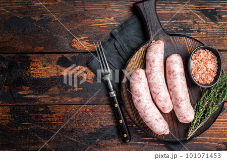 Fresh Raw Bratwurst meat sausages ready for cooking on wooden board. Wooden background. Top view. Copy space Fresh Raw Bratwurst meat sausages ready for cooking on wooden board. Wooden background. Top view. Copy space 101071453