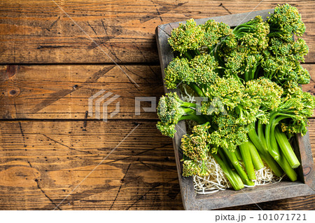 Raw Organic Fresh Broccolini Vegetable in a wooden box. Wooden background. Top view. Copy space 101071721