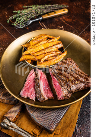 Elk steak with herbs and french fry, game meat. Dark background. Top view 101071723