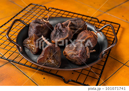 Dried persimmon. japanese Preserve fruit. Orange background. Top view 101071741