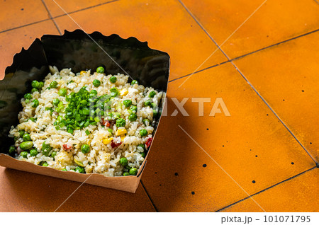 Fried rice with egg and vegetables in box take away. Orange background. Top view. Copy space Fried rice with egg and vegetables in box take away. Orange background. Top view. Copy space 101071795