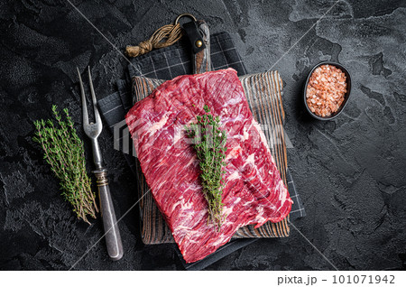 Piece of raw beef brisket, bbq smoker meat. Black background. Top view Piece of raw beef brisket, bbq smoker meat. Black background. Top view 101071942