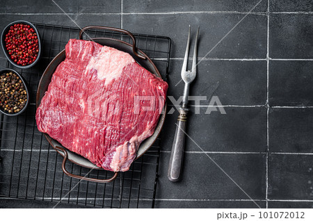 Raw piece of marble beef brisket meat with spices. Black background. Top view. Copy space Raw piece of marble beef brisket meat with spices. Black background. Top view. Copy space 101072012