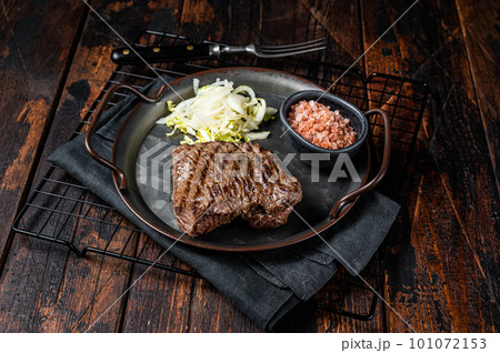 Deer venison steak with sea salt and salad. Wooden background. Top view Deer venison steak with sea salt and salad. Wooden background. Top view 101072153