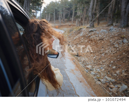 Woman on road trip traveling by rental car Woman on road trip traveling by rental car 101072494