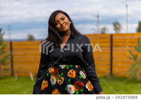 Portrait of beautiful african american woman having fun on village or suburbian. Outdoor portrait of a smiling african girl. Happy cheerful female laughing in countryside summer time and inclusion Portrait of beautiful african american woman having fun on village or suburbian. Outdoor portrait of a smiling african girl. Happy cheerful female laughing in countryside summer time and inclusion 101073069