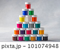 Pyramid of colorful gouache cans on gray background 101074948