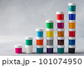 Multicolored gouache cans stacked as step stair 101074950