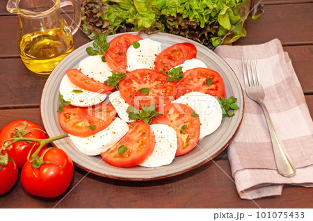Tomato and mozzarella Caprese salad with sauce Tomato and mozzarella Caprese salad with sauce 101075433