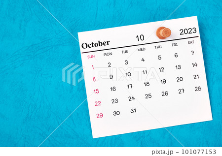 The October 2023 and wooden push pin on blue background. The October 2023 and wooden push pin on blue background. 101077153
