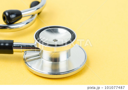A Stethoscope medical on yellow color Background. 101077487