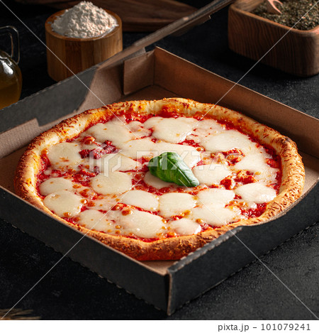 Take away backed margherita pizza with cheese Take away backed margherita pizza with cheese 101079241