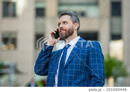 image of businessman call on phone and talk. businessman has phone call outdoor. 101080446