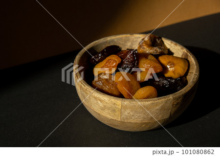Eco wooden Bowl with different Mix dried fruits apricots prunes figs. Healthy food lifestyle. Vegan dessert snack. shadows Isometric  101080862