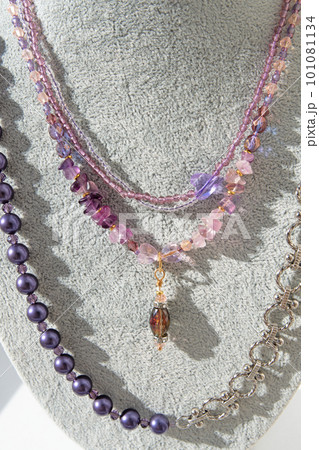 various fashionable author's necklaces with precious stones and natural pearls are presented on model. fashion and handmade concept. close up various fashionable author's necklaces with precious stones and natural pearls are presented on model. fashion and handmade concept. close up 101081134