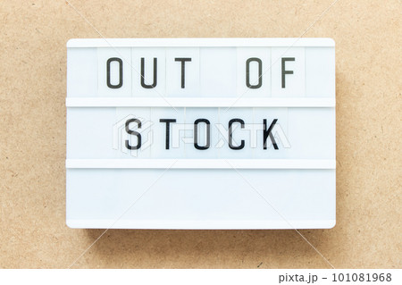 Lightbox with word out of stock on wood background 101081968