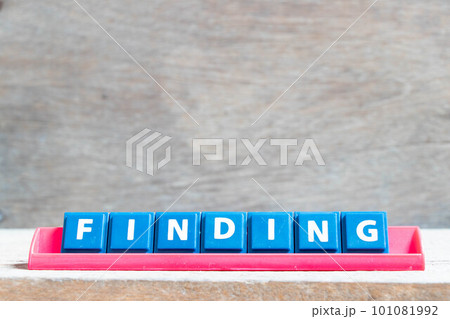 Tile alphabet letter with word finding in red color rack on wood background Tile alphabet letter with word finding in red color rack on wood background 101081992