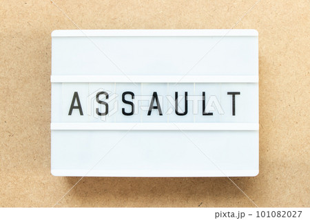Lightbox with word assault on wood background Lightbox with word assault on wood background 101082027