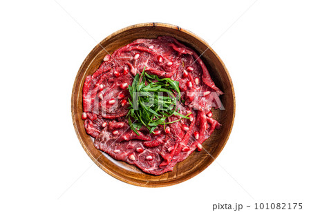 Classic beef meat carpaccio with arugula and pomegranate seeds. Isolated on white background. 101082175