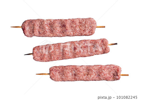 Raw Turkish Adana shish kebab on butcher table. Isolated on white background. 101082245