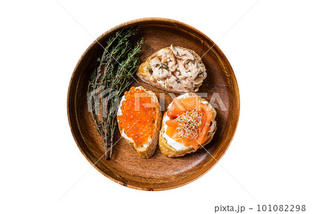 Bruschetta with Hot Smoked salmon, red caviar and herbs. Isolated on white background. Bruschetta with Hot Smoked salmon, red caviar and herbs. Isolated on white background. 101082298