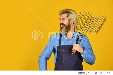 Tools for roasting meat outdoors. Picnic and barbecue. ready for barbecue party. Culinary concept. summer weekend. happy hipster hold cooking utensils for barbecue. bearded man chef. copy space 101083277