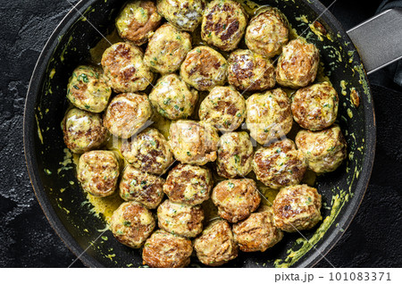Swedish Meatballs with Cream Sauce in a skillet. Black background. Top view 101083371