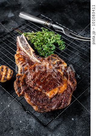 BBQ Grilled Tomahawk or rib eye with bone beef steak. Black background. Top view 101083411