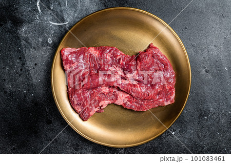 Alternative choice steak - Skirt or Machete, raw beef meat. Black background. Top view 101083461