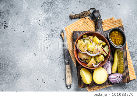 Cooking Traditional German potato salad - Kartoffelsalat. Gray background. Top view. Copy space Cooking Traditional German potato salad - Kartoffelsalat. Gray background. Top view. Copy space 101083570