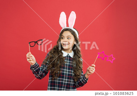 Eyewear booth props. Little cute bunny. Having fun. Schoolgirl bunny ears. Girl in Easter bunny at egg hunt. Party and social event. Family holiday. Traditional party activities. Smart bunny Eyewear booth props. Little cute bunny. Having fun. Schoolgirl bunny ears. Girl in Easter bunny at egg hunt. Party and social event. Family holiday. Traditional party activities. Smart bunny 101083625